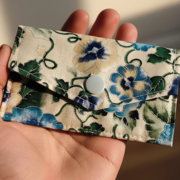 Floral patterned fabric pouch on a dark background