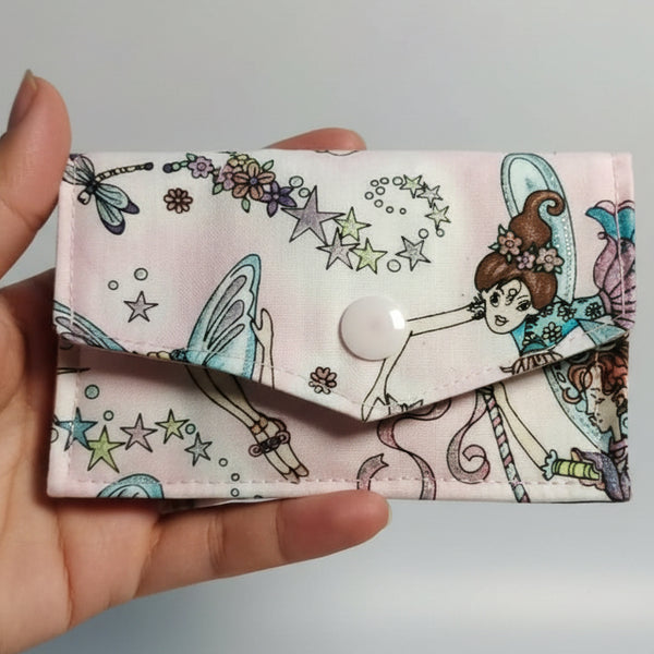 Floral and fairy patterned fabric on a dark background